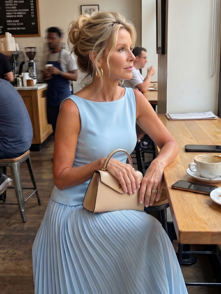 Women's summer fashion: a chic sleeveless structured top paired with a long, pleated maxi skirt set.
