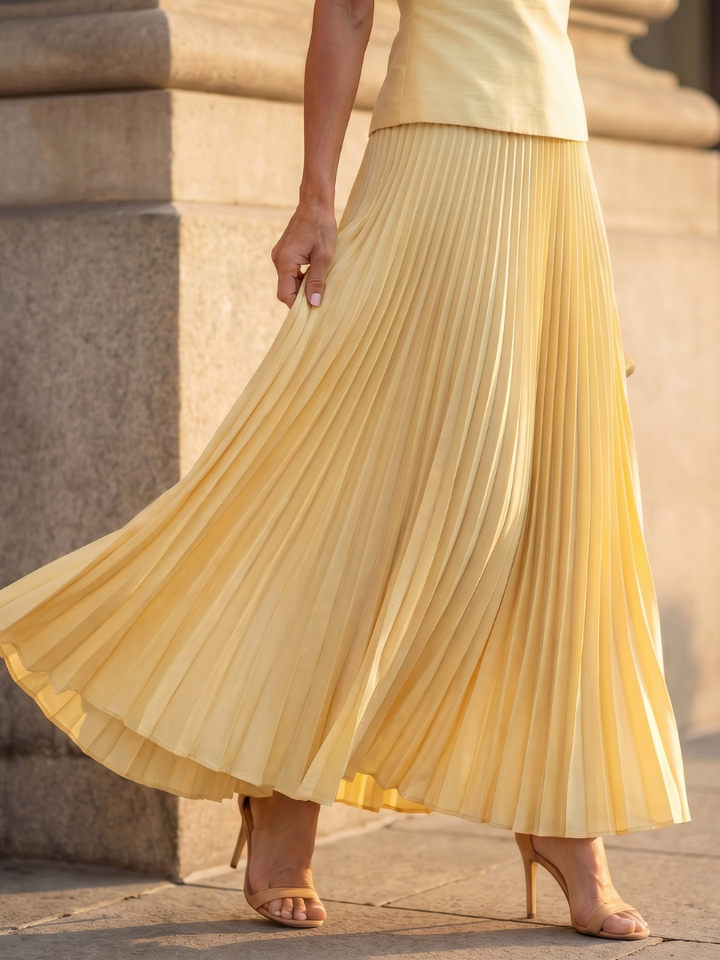Women's structured bodice top with a matching long pleated skirt. This elegant two piece set is occasion ready.