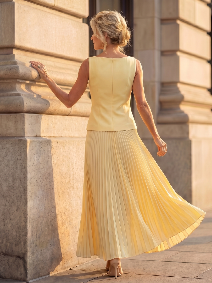 Front view of a women's coordinated skirt set: sleeveless structured top & elegant pleated maxi skirt.
