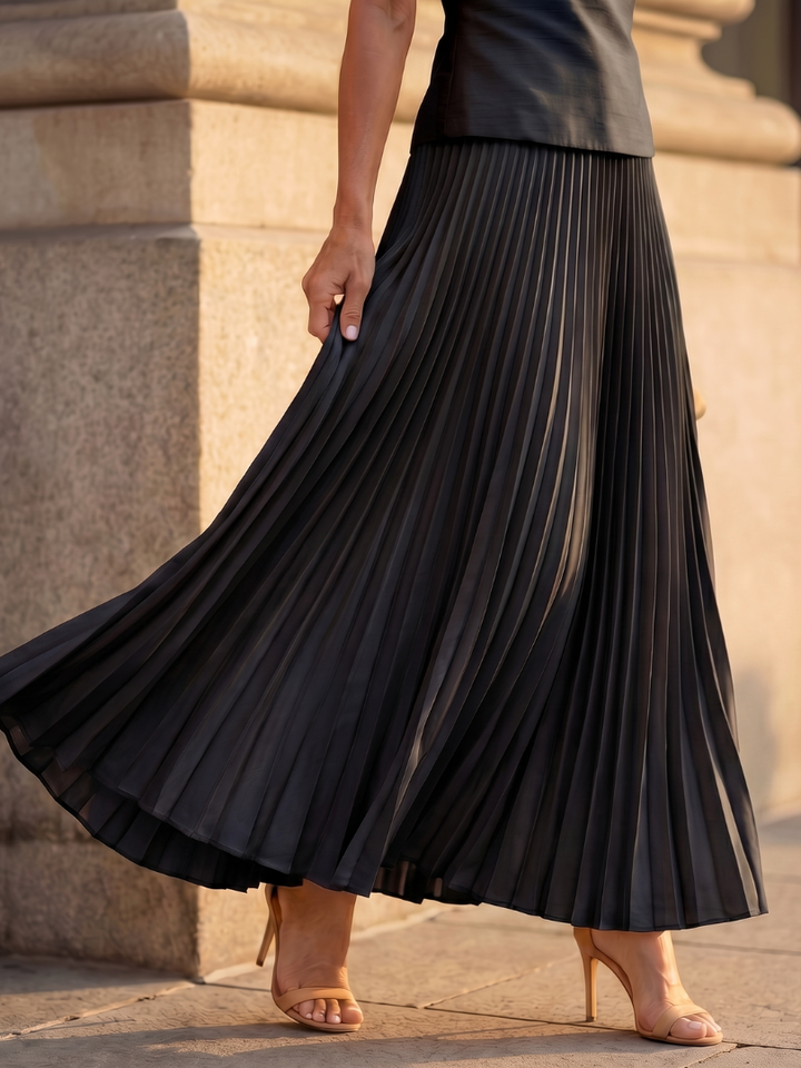 Stylish women's summer outfit: a sleeveless structured bodice and a beautiful flowing pleated maxi skirt set.
