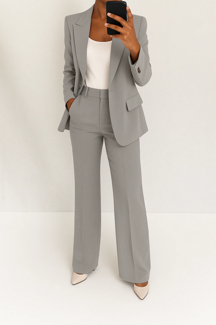 Sophisticated women's tailored blazer, part of an elegant two-piece suit, ideal for professional business attire.
