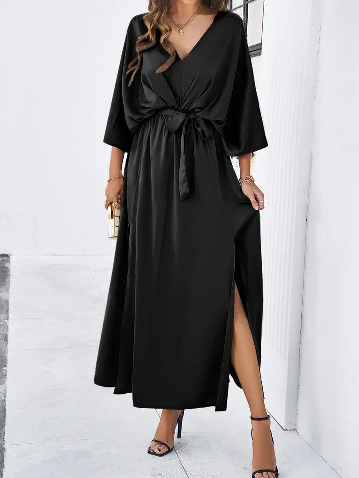 Bold red V-neck batwing maxi dress for women, with a sophisticated bow belt & high side slit. Ideal for evening gowns.