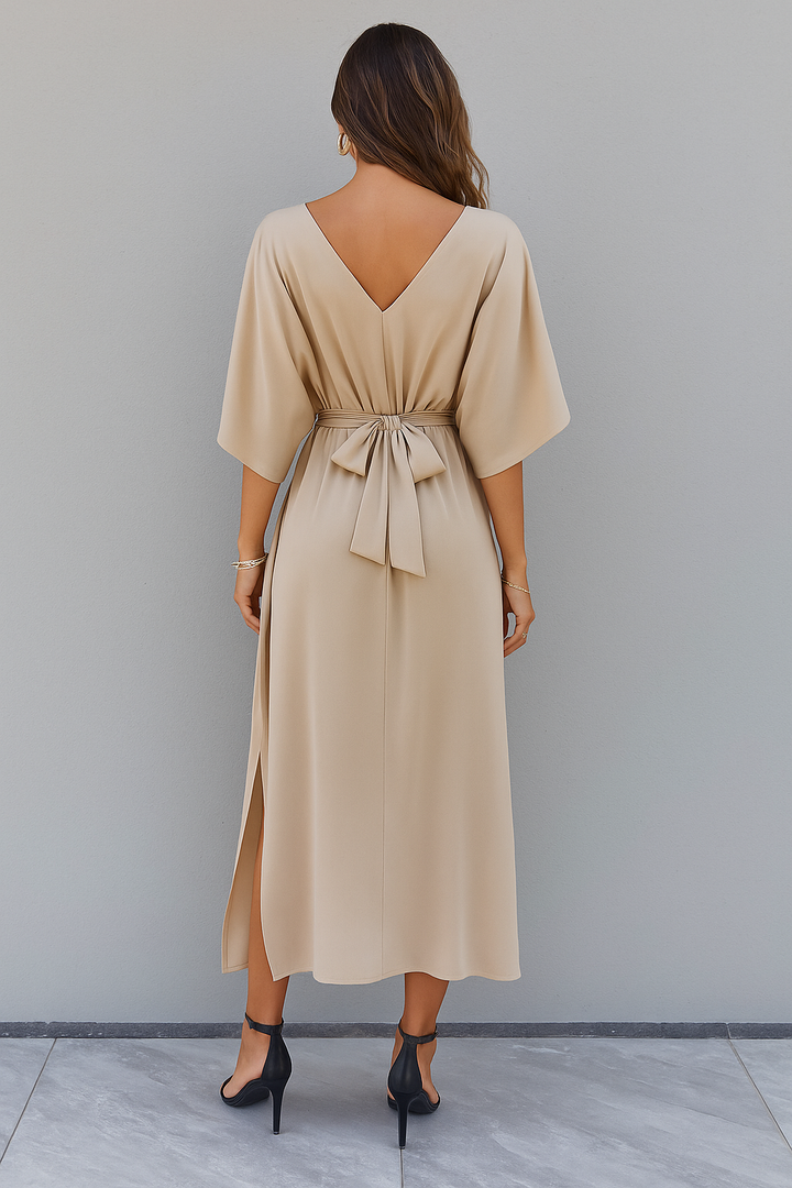 Long women's batwing sleeve maxi dress, V-neck, with a delicate bow belt & side slit for an elegant, flowing silhouette.