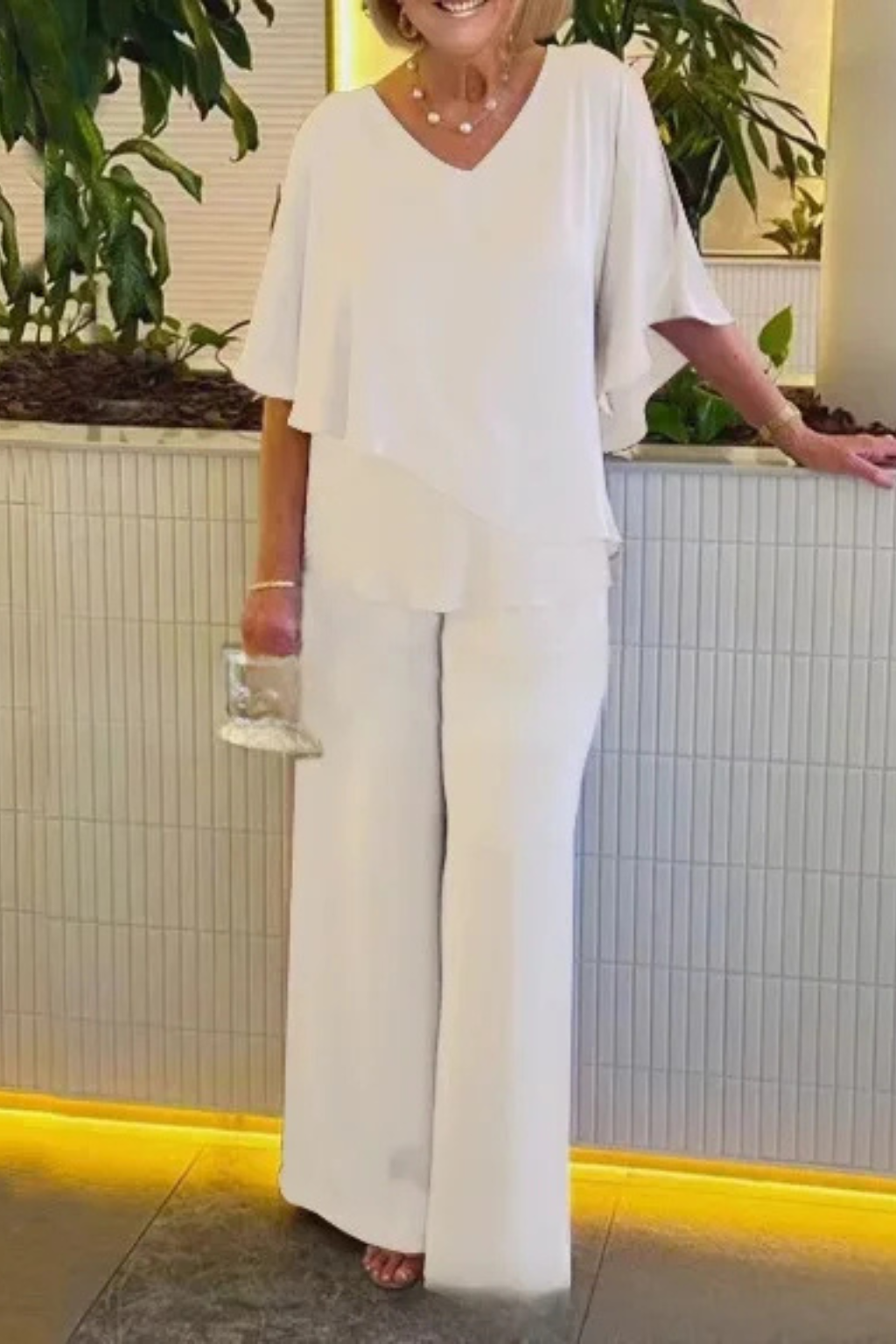 Sophisticated khaki women's matching set: batwing V-neck top and flowy wide leg pants. Travel-friendly.