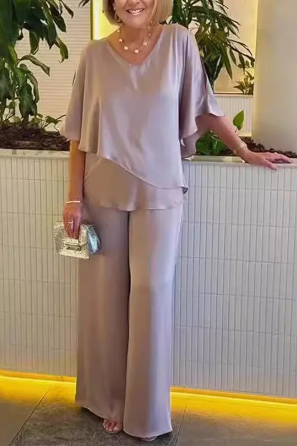 Women's gold two-piece set: elegant V-neck batwing top paired with comfortable wide leg pants.