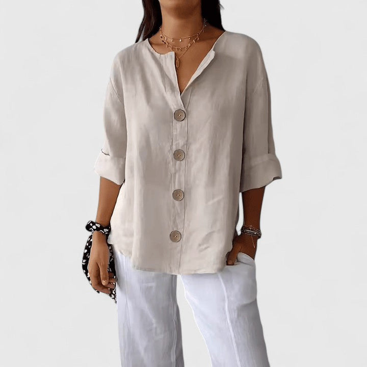 Chic women's V-neck button-down blouse, elegant design with long sleeves, suitable for versatile styling.