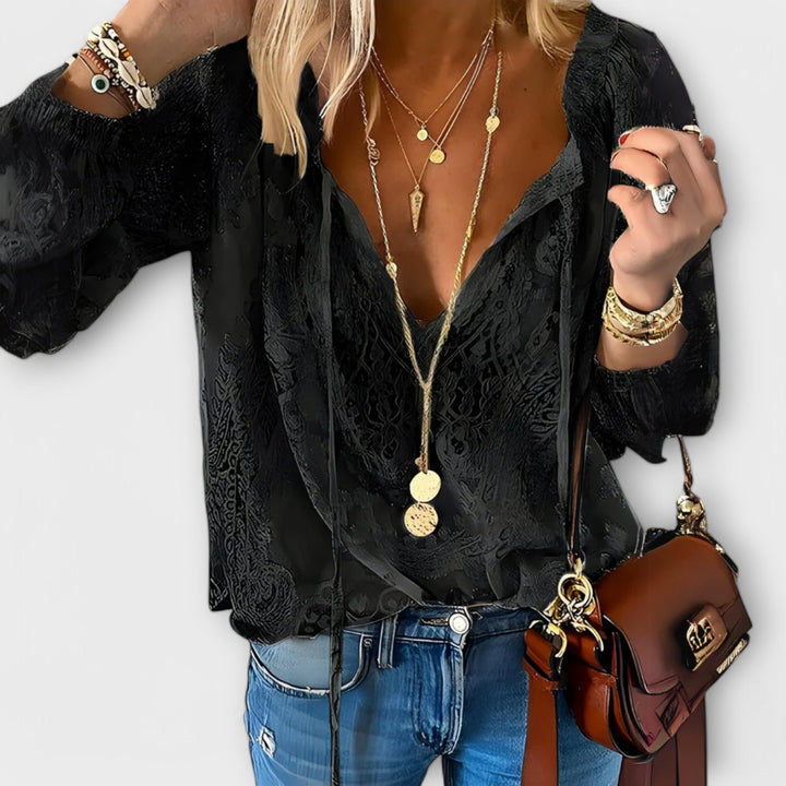 Chic white V-neck long sleeve lace blouse for women. Elegant, versatile, and feminine, ideal for various occasions.