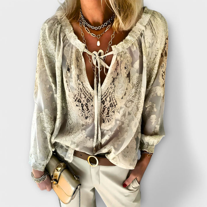 Versatile black V-neck long sleeve lace top. Elegant women's blouse with a relaxed fit for chic office or evening wear.