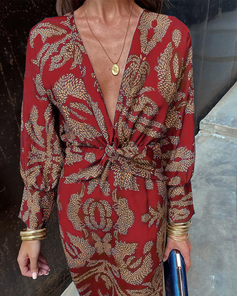 Elegant women's patterned midi dress with a V-neck and chic knot detail, long sleeves for a special occasion.