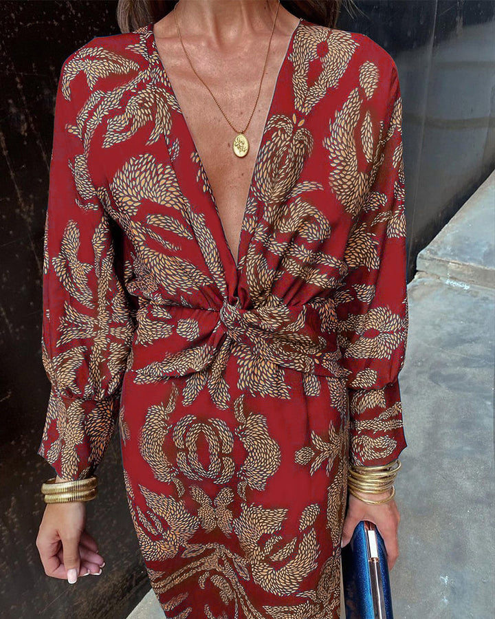 Elegant women's patterned midi dress with a V-neck and chic knot detail, long sleeves for a special occasion.