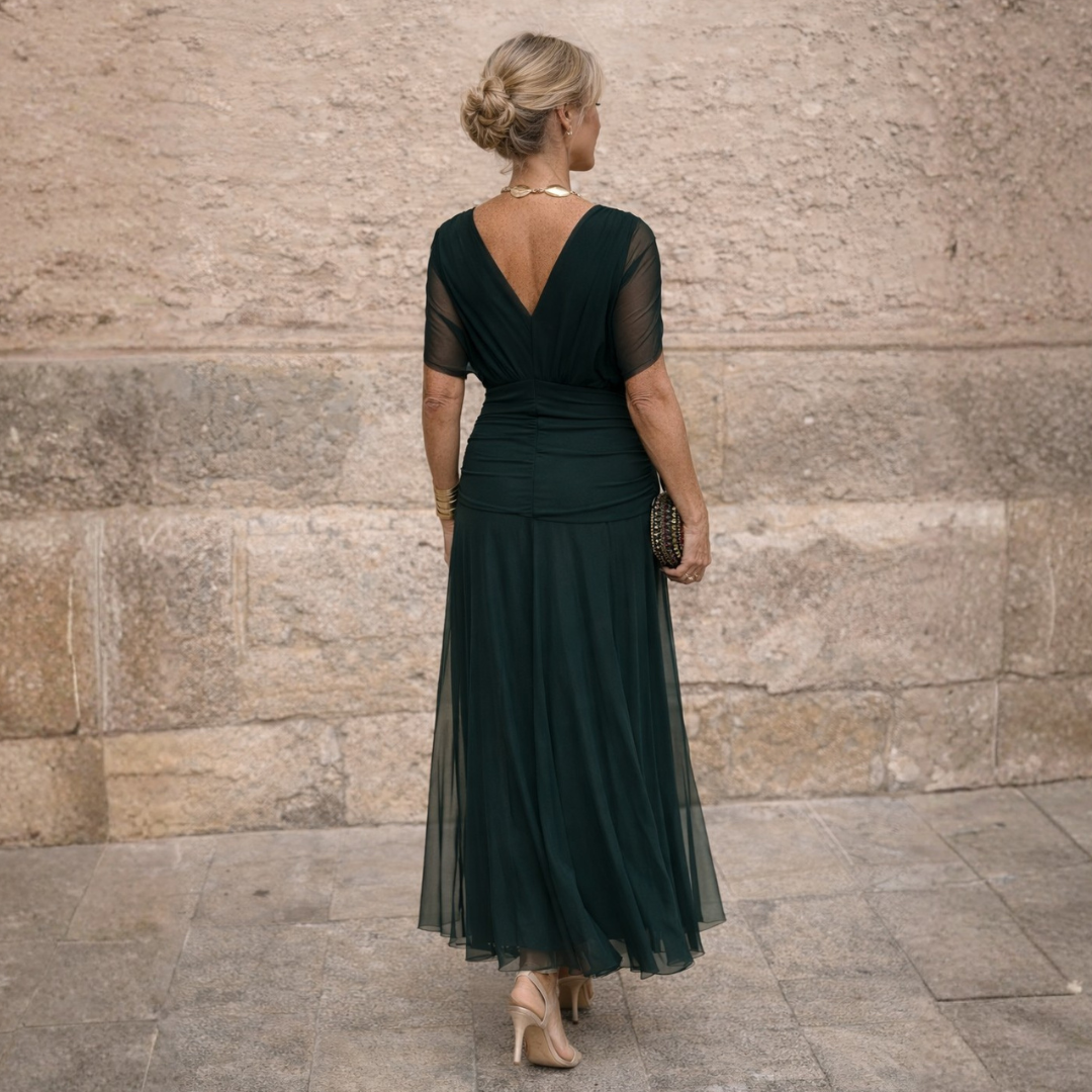 Sophisticated women's wedding guest dress: V-neck midi with graceful flutter sleeves.