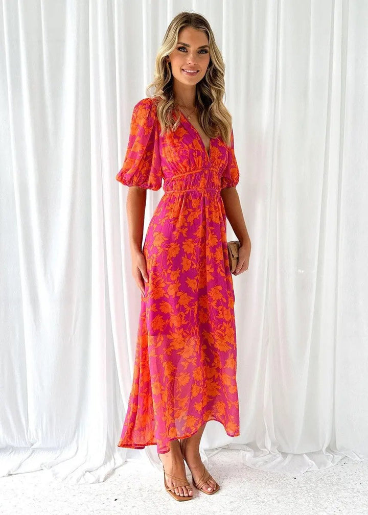 Chic women's puff sleeve midi dress with V-neck, ideal for spring/summer parties. Features an elastic waist.