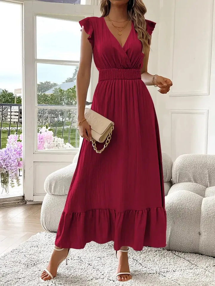 Women's V-neck maxi dress, light and airy with ruffle trim, ideal for a breezy summer day.