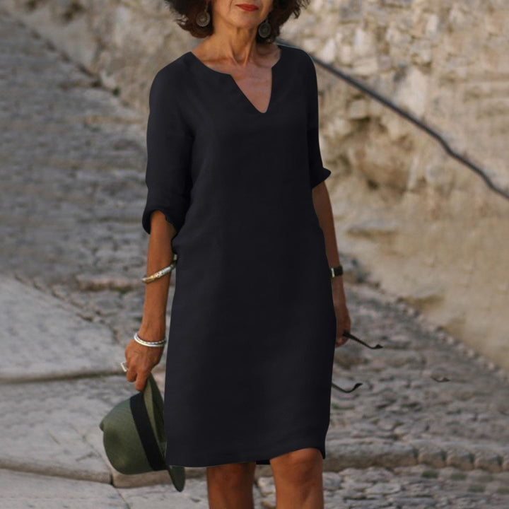Detail of chic V-neck on a women's summer midi dress, highlighting elegant design and comfortable fit.