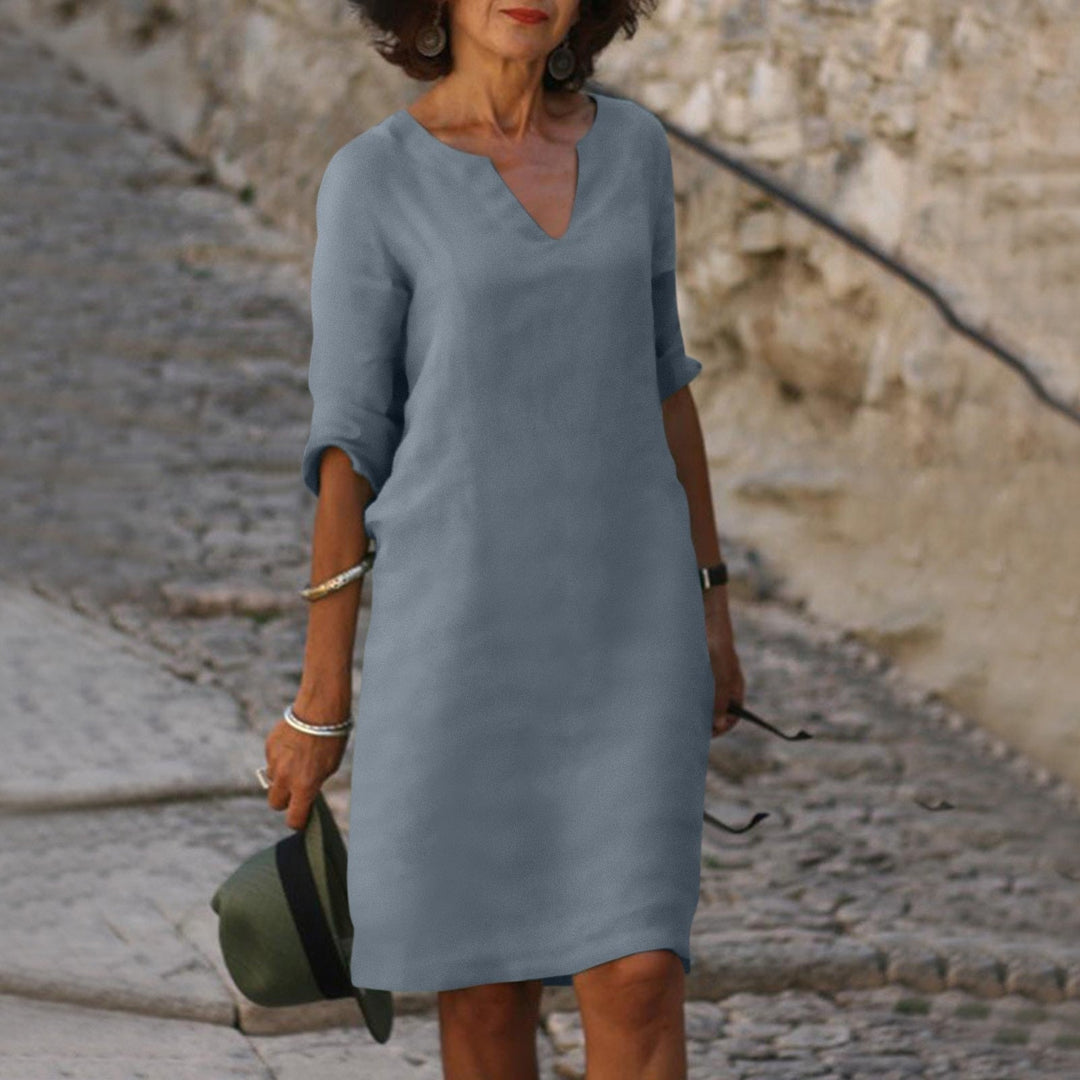 Women's casual midi dress with a flowing silhouette, V-neck, ideal for summer vacation wear and spring fashion.
