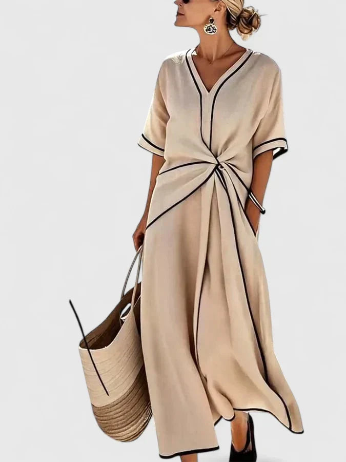 Elegant women's vertical stripe summer dress. Lightweight, flowing fabric, and short sleeves for warm weather style.