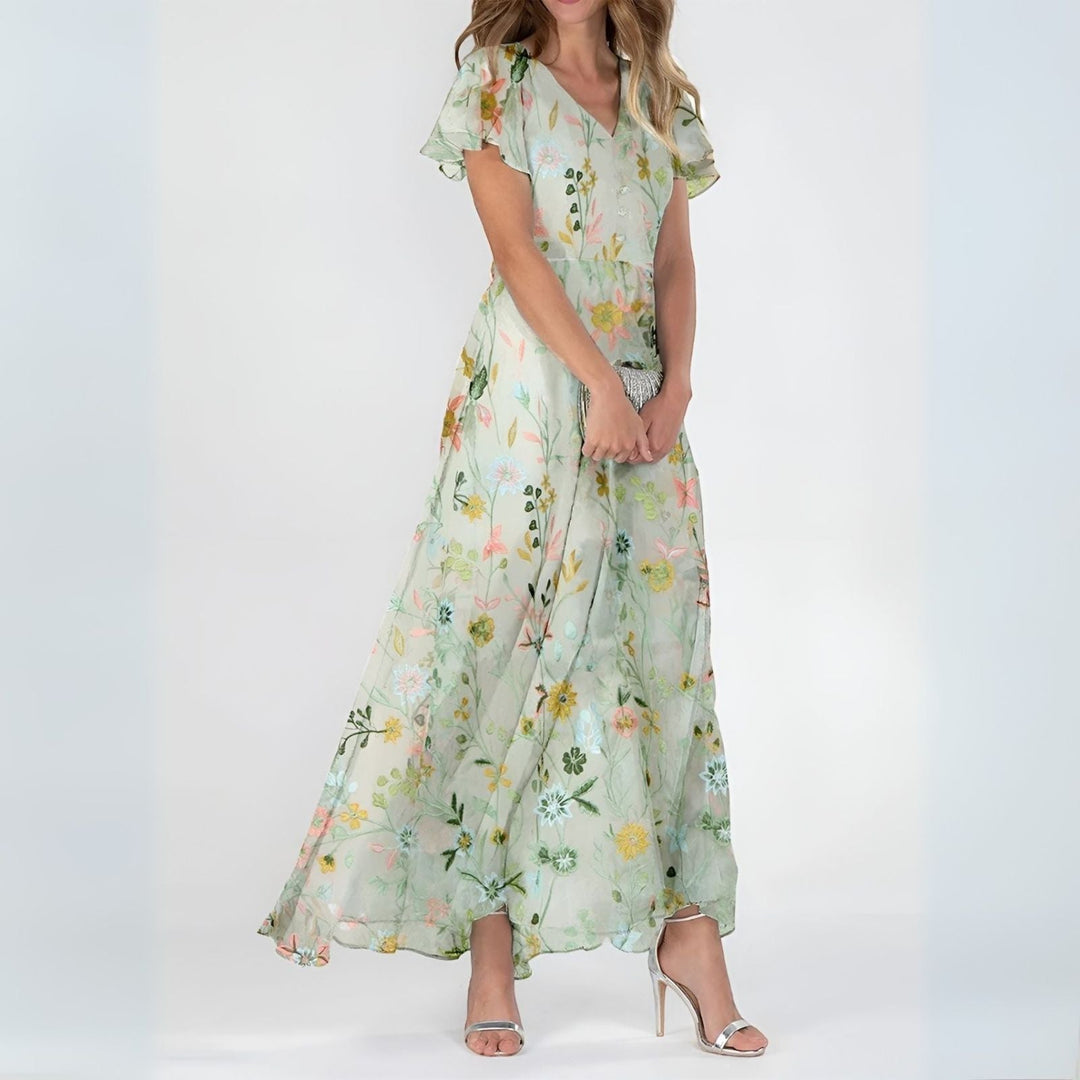 Beautiful women's elegant maxi dress featuring a soft watercolor floral print, ideal for summer & garden parties.