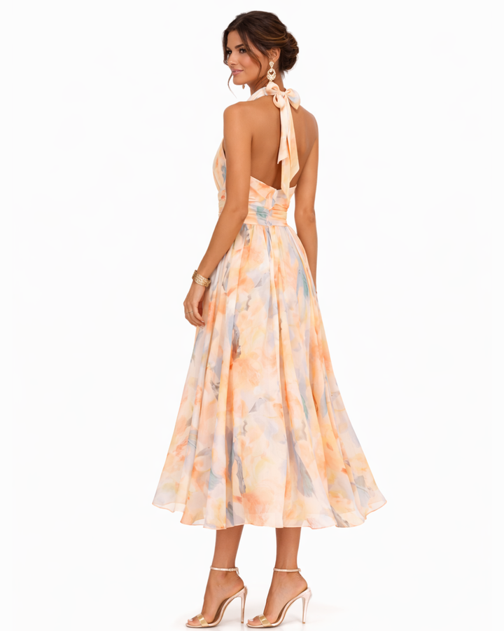 Women's sophisticated watercolor print maxi dress with a flattering halter neck, ideal for elegant events.