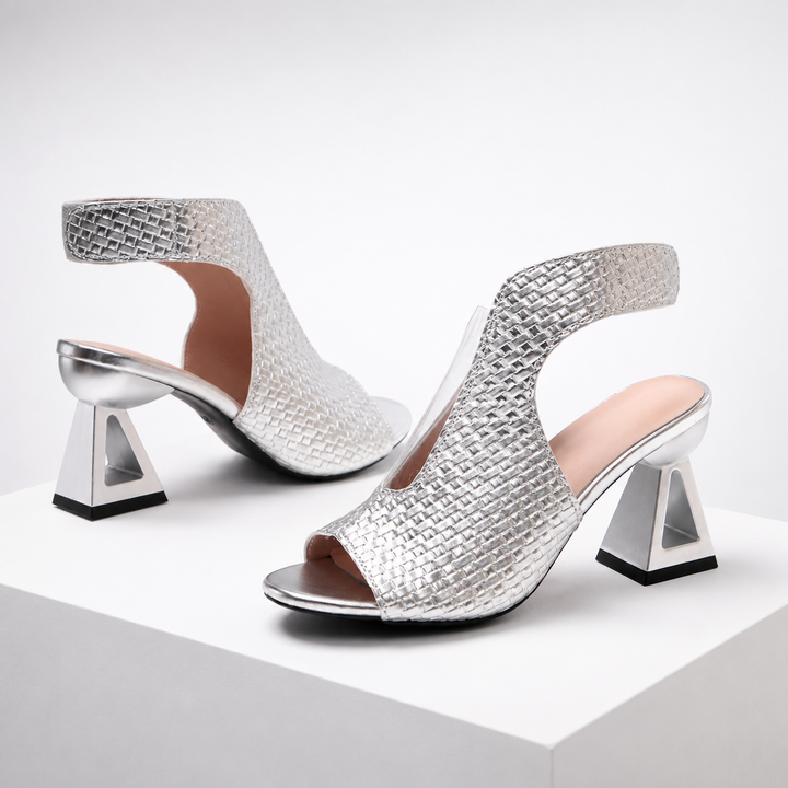 Dressy metallic open-toe weave heels with a unique geometric architectural heel, elevating any formal look.