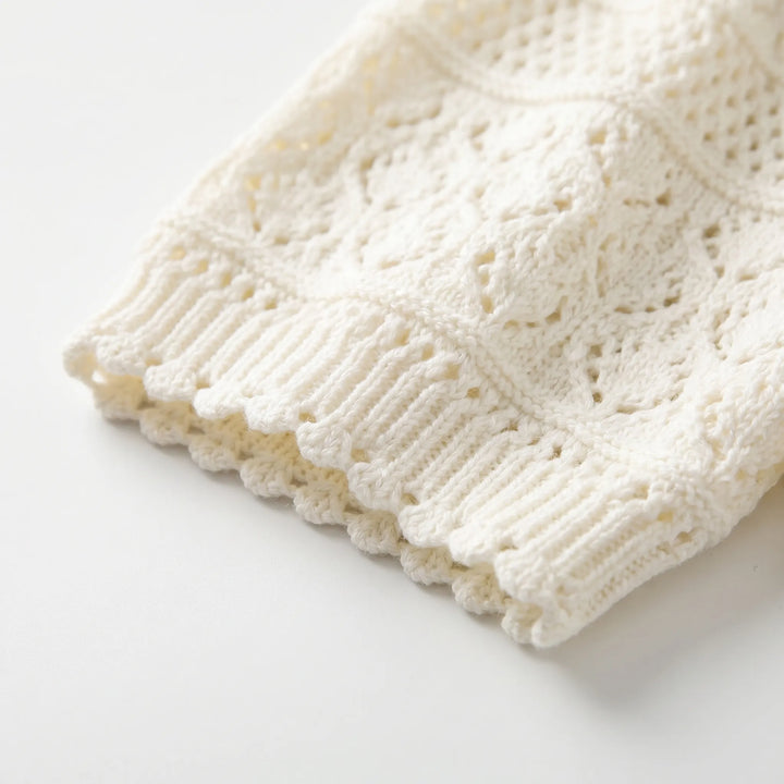 Women's white short-sleeve crochet knit blouse with a chic polo collar. Stylish & comfortable for summer outfits.
