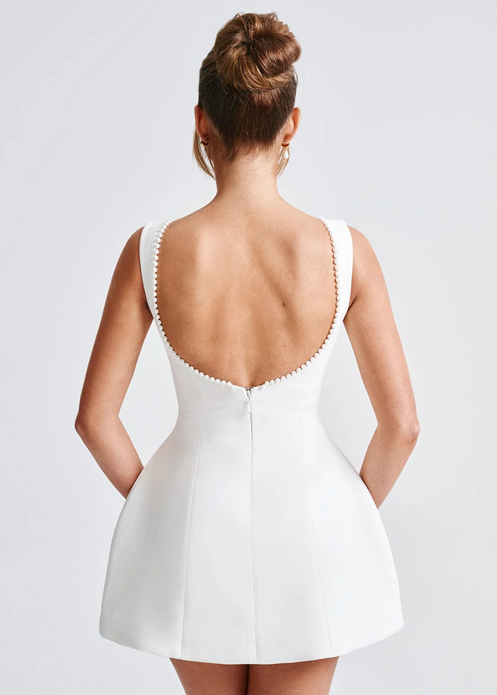 Women's elegant mini dress with a trendy open back & bow detail, perfect for special occasion or evening wear.