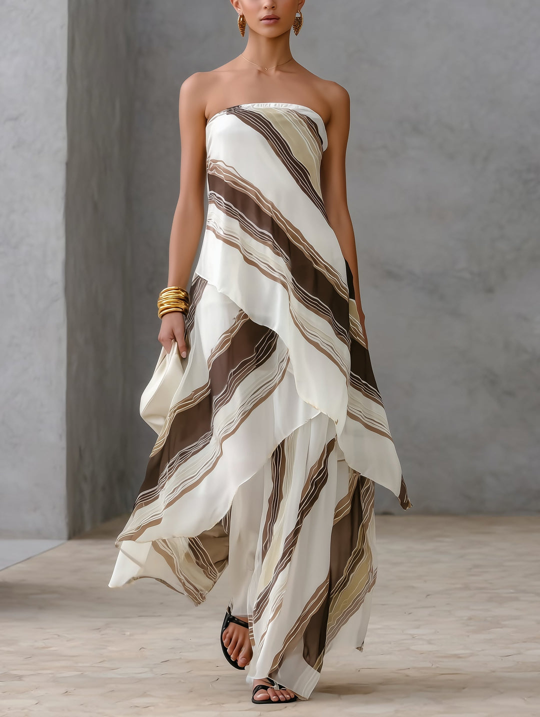 Elegant women's white striped strapless maxi dress with asymmetric hem, perfect for summer evenings & resort wear.