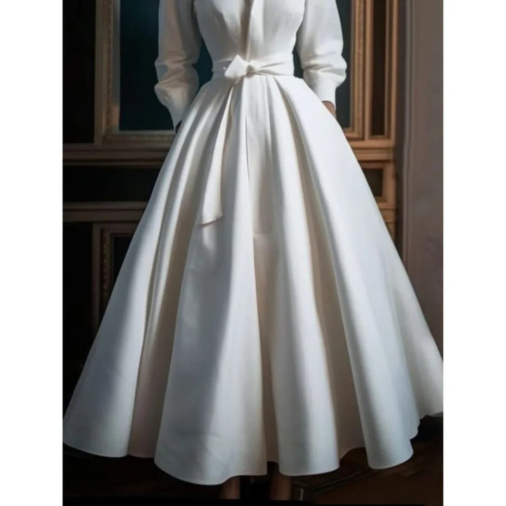 White women's V-neck A-line midi dress featuring long sleeves, an elegant choice for formal spring and summer events.