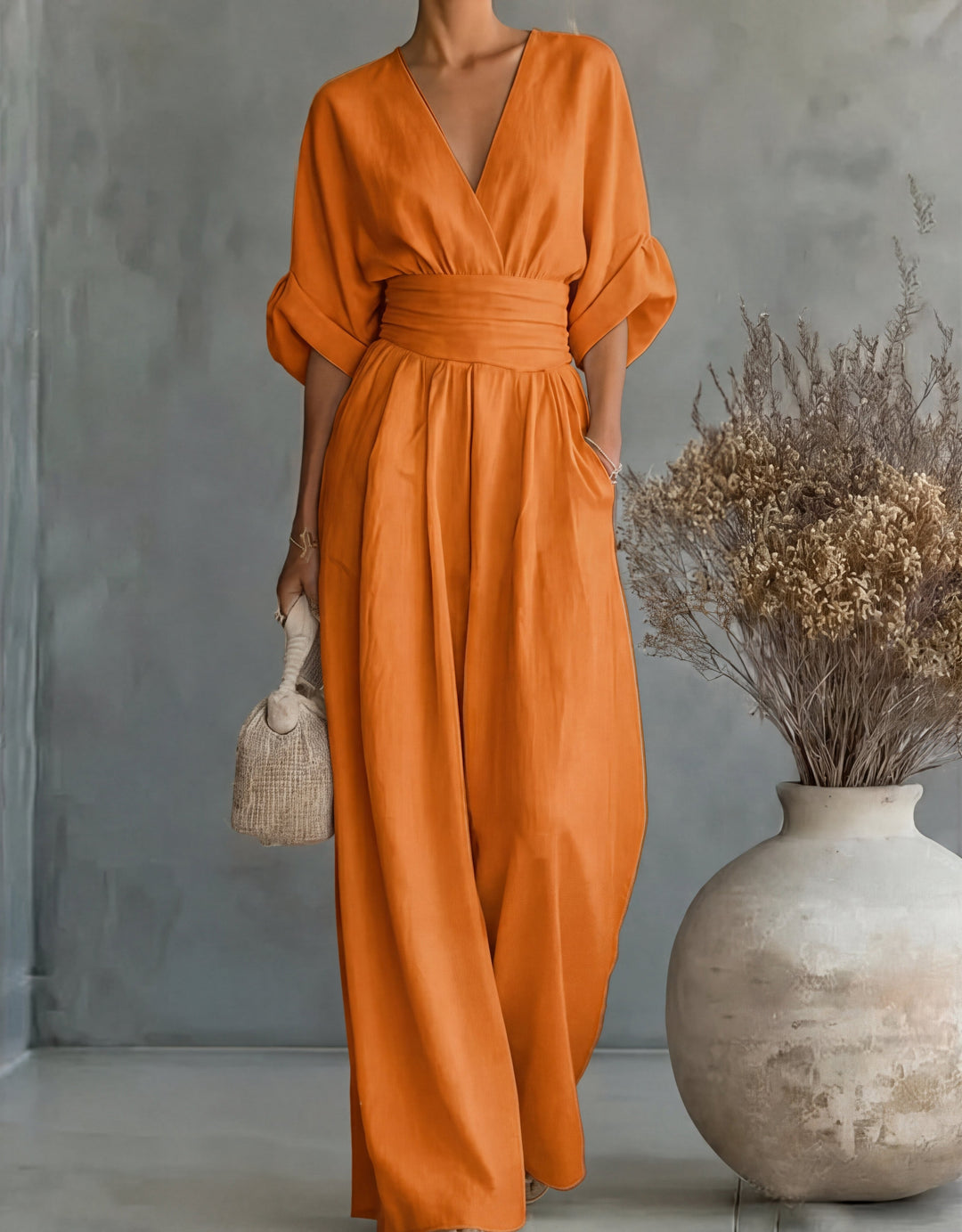Elegant women's jumpsuit with wide legs and wrap front. Perfect for versatile spring fashion.