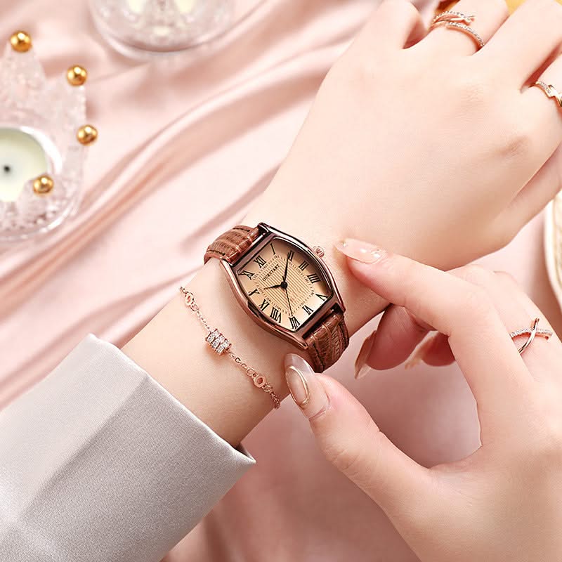 Close-up of women's elegant wristwatch dial with intricate Roman numerals and a clear analog display.