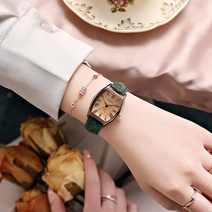 Women's elegant Roman numeral wristwatch on wrist, a classic analog display fashion accessory for any outfit.