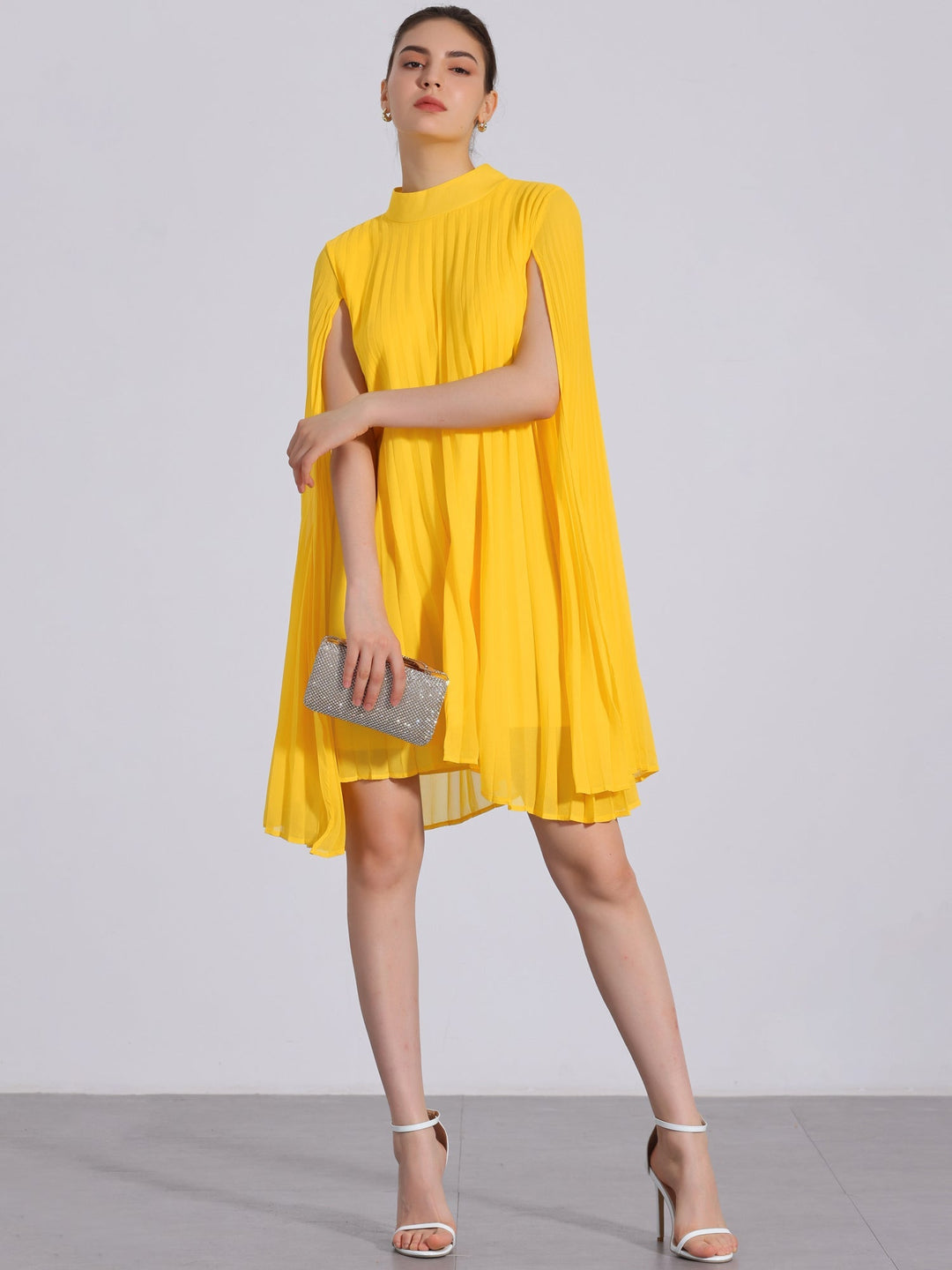 Elegant women's yellow pleated swing dress with cape sleeves & mock neck. Ideal for parties.