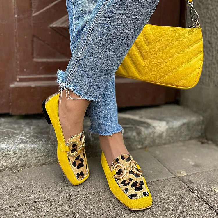 Elegant women's yellow slip-on loafers with penny toe detail, perfect for comfortable casual or office wear.