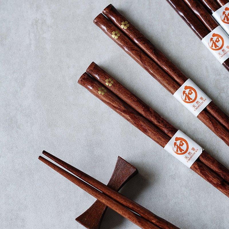 Set of 5 reusable wooden chopsticks featuring a beautiful golden cherry blossom pattern, ideal for elegant tableware.