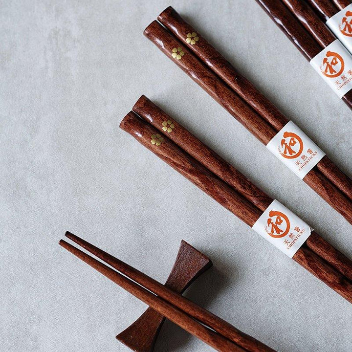 Set of 5 reusable wooden chopsticks featuring a beautiful golden cherry blossom pattern, ideal for elegant tableware.