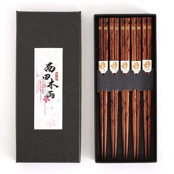 Five pairs of elegant wooden chopsticks, each featuring a unique golden cherry blossom design, great for tableware.