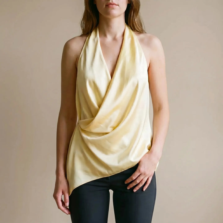 Elegant yellow women's draped halter top with an asymmetrical hem, perfect for chic summer or evening fashion.