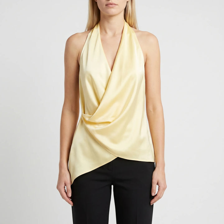 Chic women's sleeveless halter blouse, featuring a modern draped design and stylish asymmetrical hem.