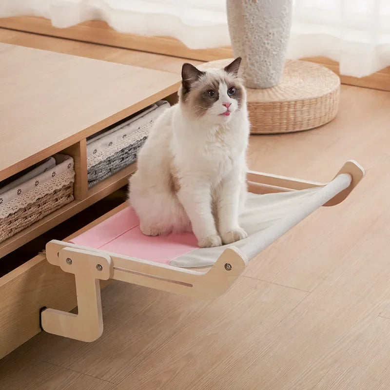 Elevated cat hammock with natural wood frame & soft gray fabric, perfect for pet relaxation & modern pet furniture.