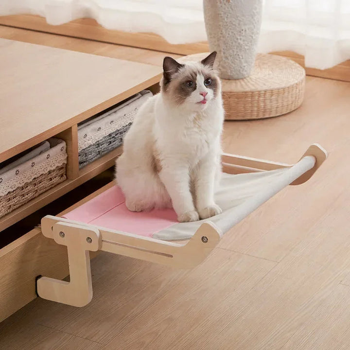 Elevated cat hammock with natural wood frame & soft gray fabric, perfect for pet relaxation & modern pet furniture.