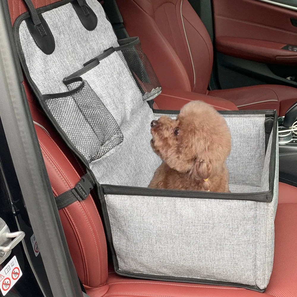 Foldable elevated dog booster seat for car travel, showing bottom storage compartment and soft, comfortable bed.