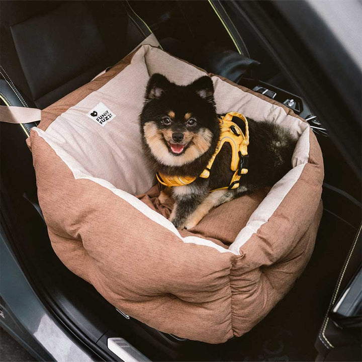 Secure dog car seat bed, beige, with safety anchors, offering elevated views and a cozy ride for pets.