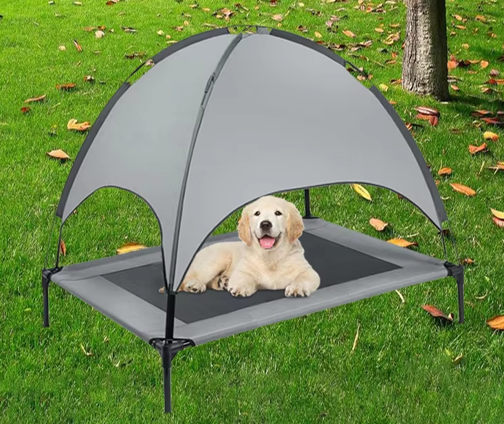 Portable elevated dog bed with sun canopy, ideal for travel and keeping pets cool outdoors.