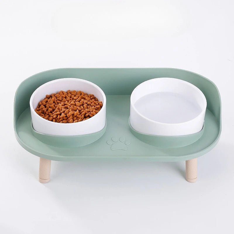 Close-up of a stylish elevated pet feeding station showing non-slip stainless steel bowls in a sturdy bamboo frame