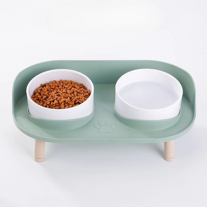 Close-up of a stylish elevated pet feeding station showing non-slip stainless steel bowls in a sturdy bamboo frame