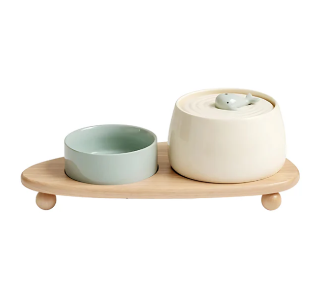 Two ceramic pet bowls in a natural wood stand, a modern and practical pet feeding station.