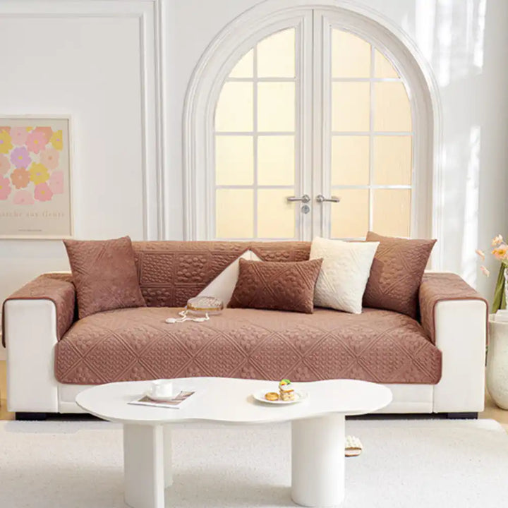 Close-up of plush quilted sofa cover showcasing the embossed geometric texture and quality.
