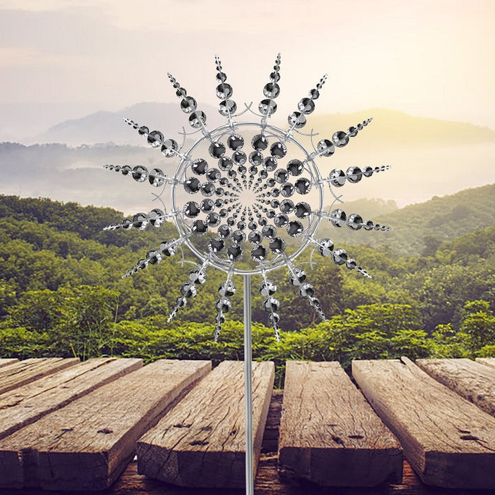 Magical metal windmill spinner adds captivating motion to your garden. Kinetic outdoor art, a unique patio decor piece.
