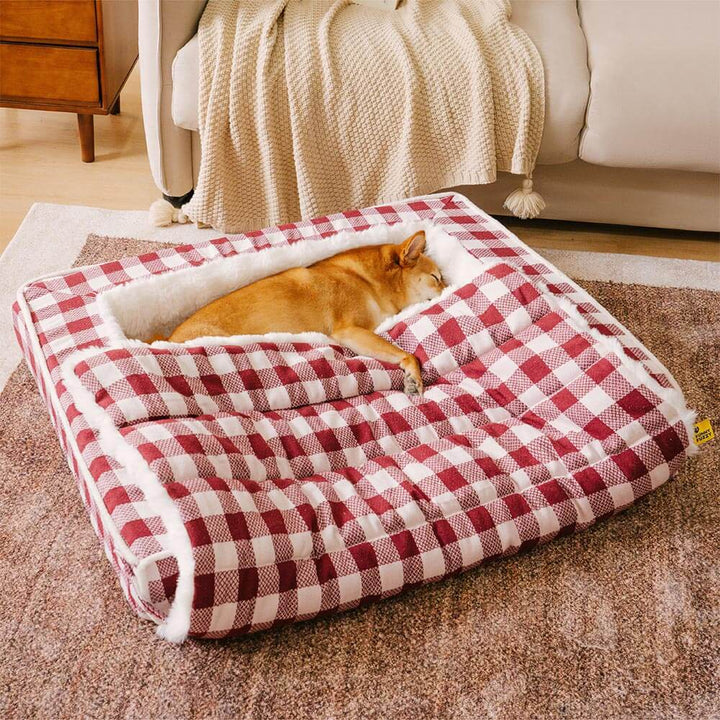 Gray plaid ergonomic dog bed, calming and washable, shown expanded for extra space.