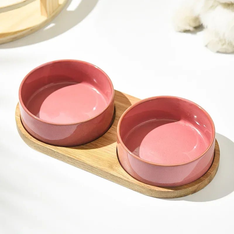 Close-up of a sturdy, dishwasher safe ceramic dog bowl with a minimalist wooden stand design.