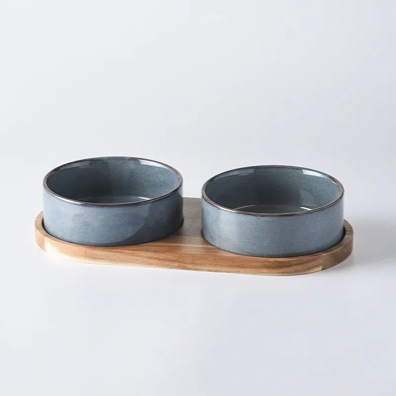 Premium pet supplies: an ergonomic ceramic bowl and matching wooden stand for small to medium pets.